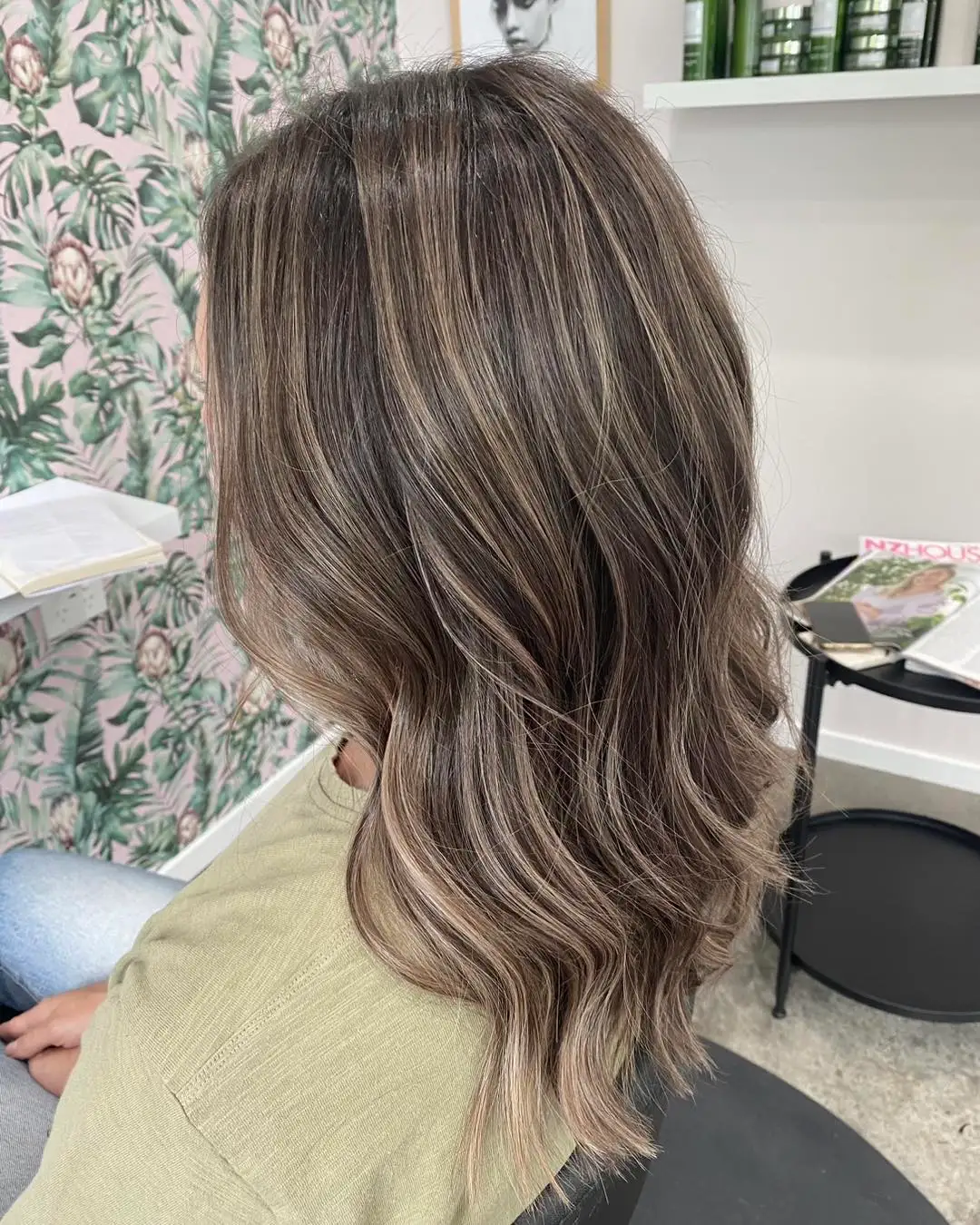 Side view of brunette mid-length waves with cool babylights