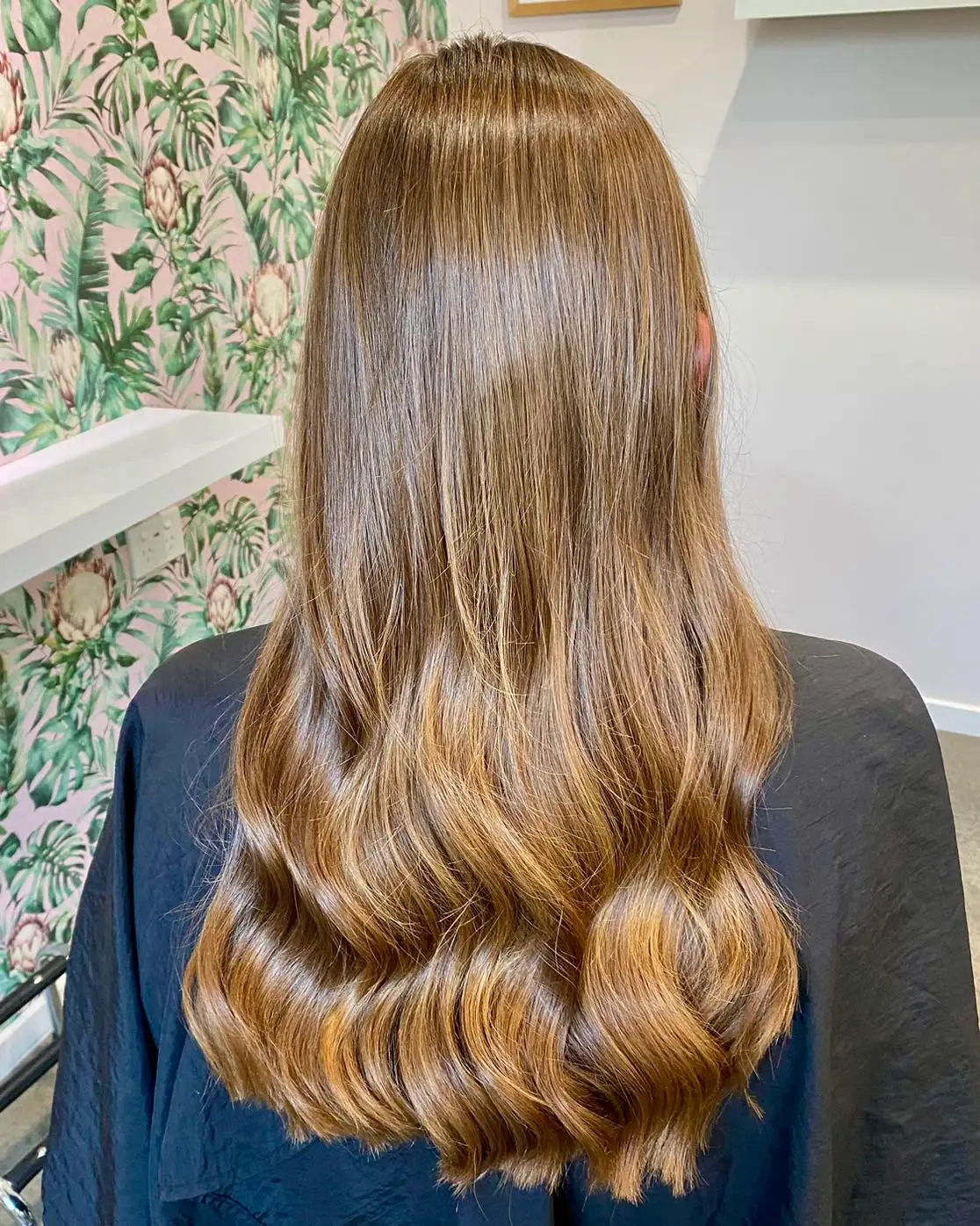 Back view of long bronde hair in polished glossy waves