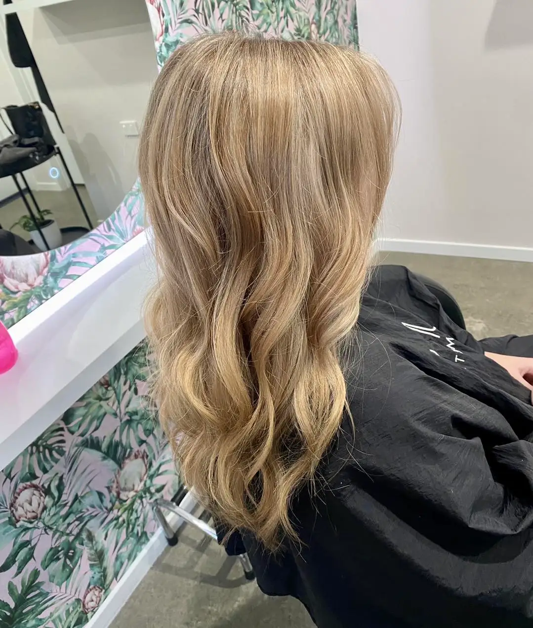 Back view of long honey blonde waves with sun-kissed lights