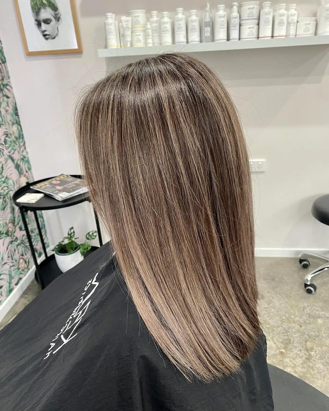 Side view of sleek mid-length mushroom brown hair with subtle highlights