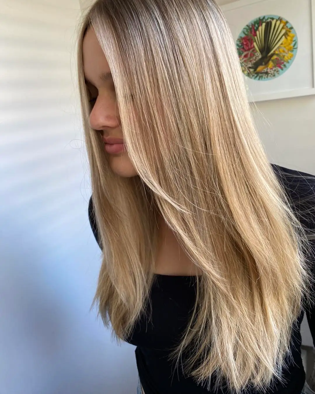 Side portrait of long sunlit blonde hair with creamy mid-lengths