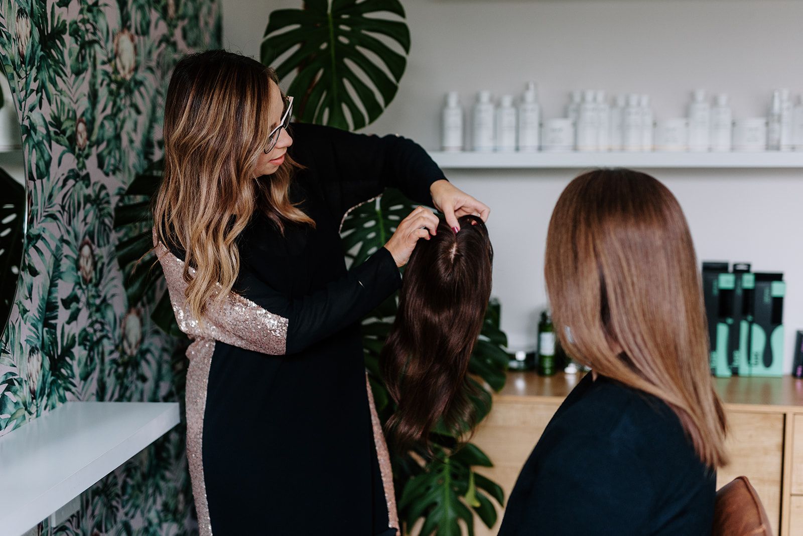 A topper being fitted and matched in to existing hair.